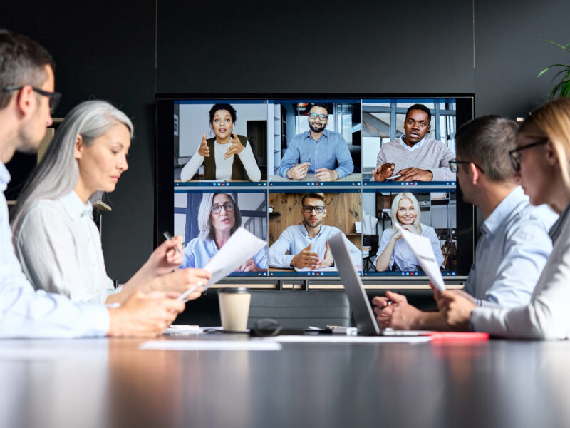 Global,Corporation,Online,Videoconference,In,Meeting,Room,With,Diverse,People