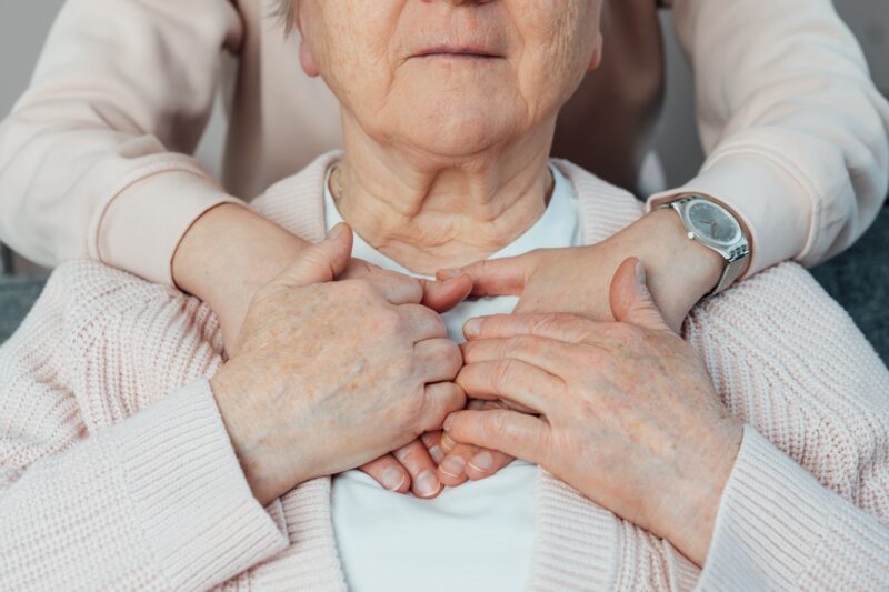 Senior,Smiling,Woman,Feeling,Young,Relative's,Or,Caregiver,Supportive,Touch